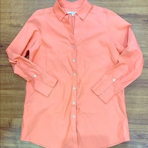 Peach colored long sleeved button up blouse